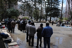 People line up for a soup kitchen organized by a Sendai-based NPO with aid from AMDA