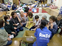 AMDA staff distributing vitamins as part of their nutrition program.